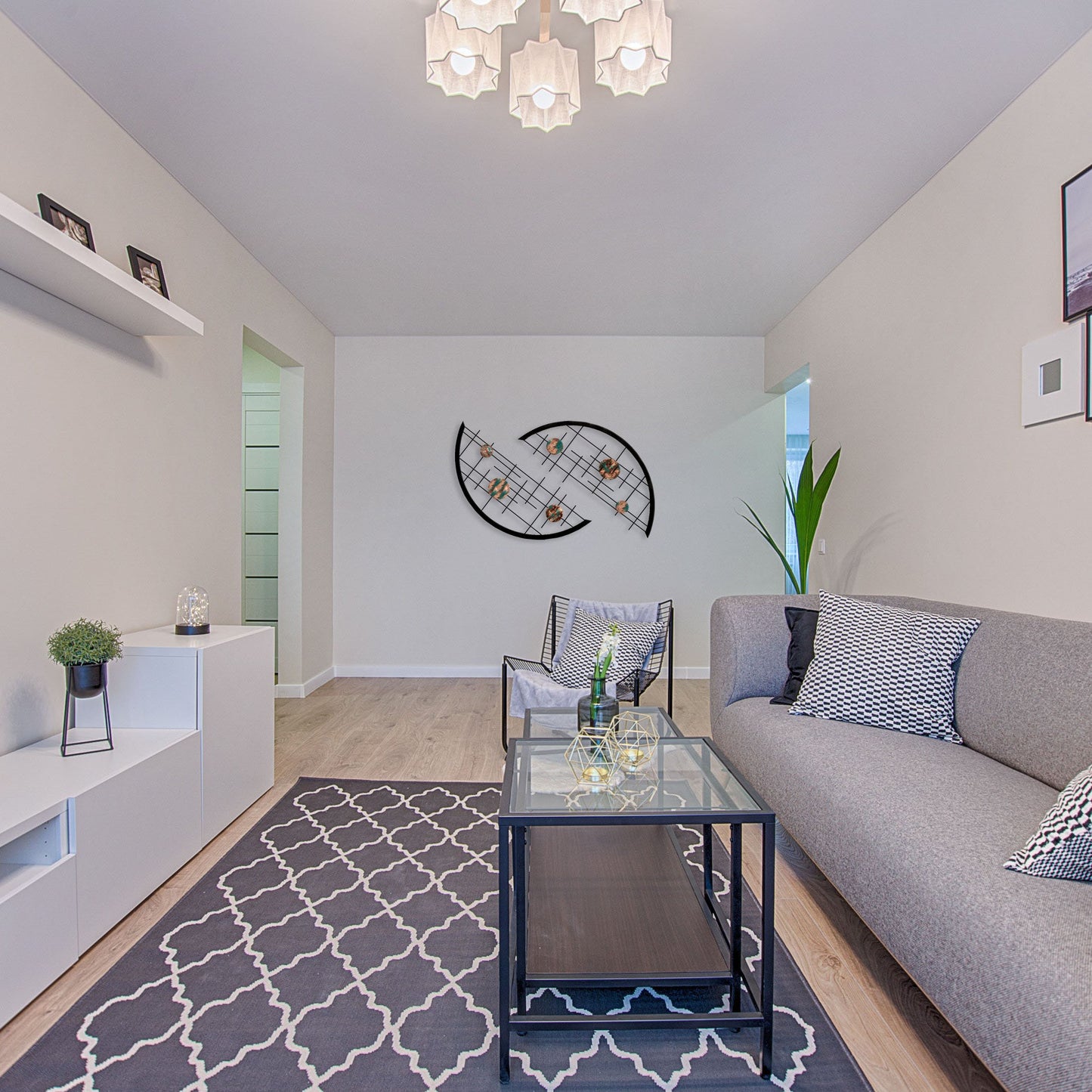 this long and neutral designed living room features arcs that have a set of teal splashed circles